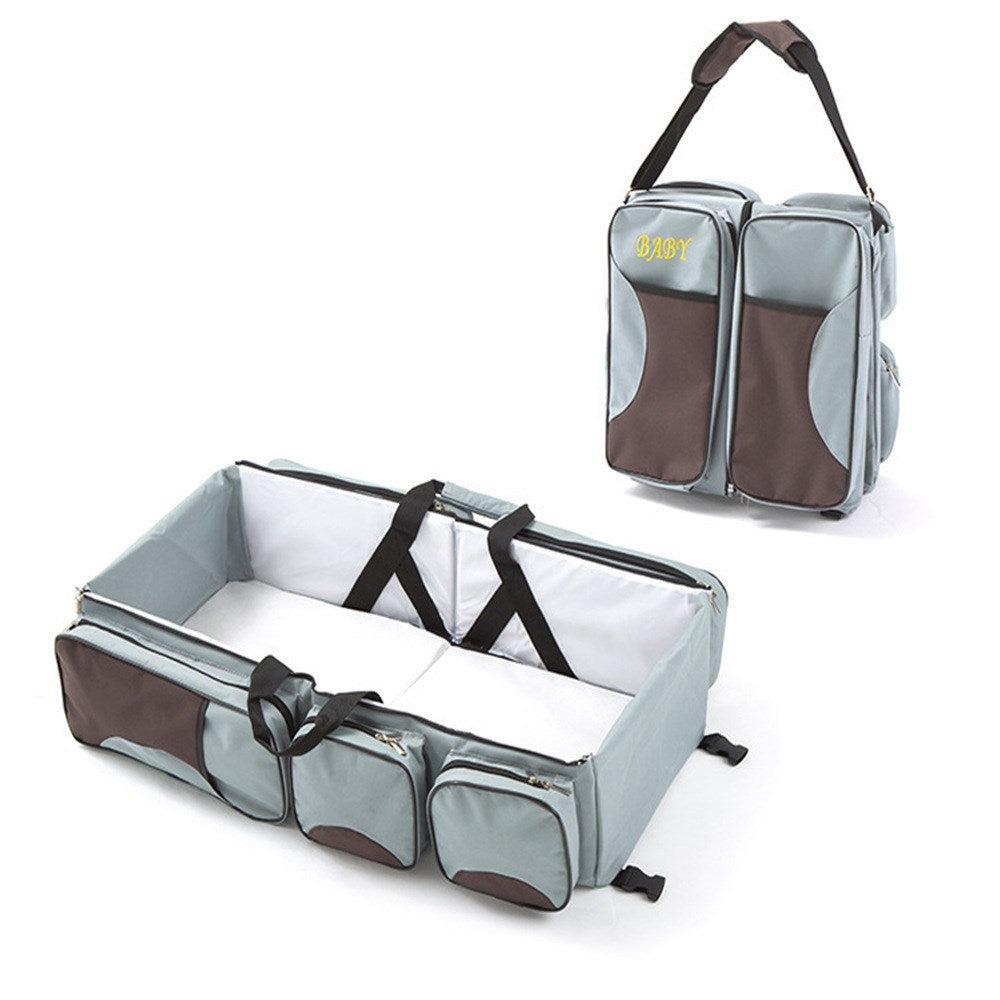 Baby Folding Bed Mommy Bag with portable baby bed, large storage compartments, and comfortable shoulder straps for travel and everyday parenting