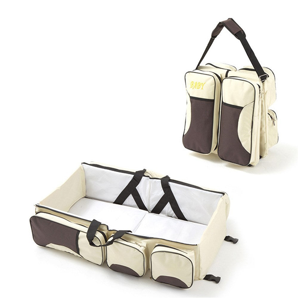 Baby Folding Bed Mommy Bag with portable baby bed, large storage compartments, and comfortable shoulder straps for travel and everyday parenting