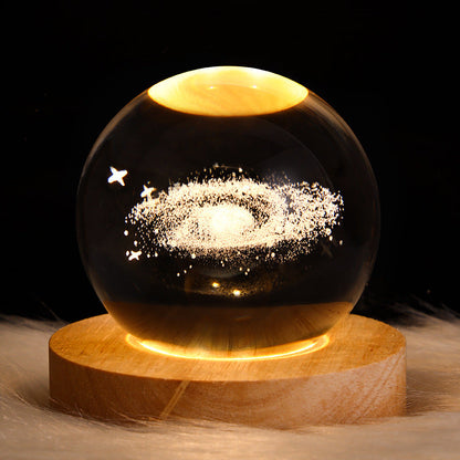 3D Galaxy Crystal Ball Night Light with USB wooden LED base featuring Moon, Saturn, Solar System, and Nebula designs for bedroom décor