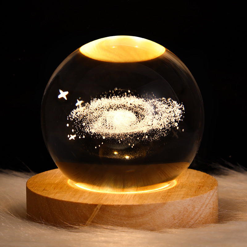 3D Galaxy Crystal Ball Night Light with USB wooden LED base featuring Moon, Saturn, Solar System, and Nebula designs for bedroom décor