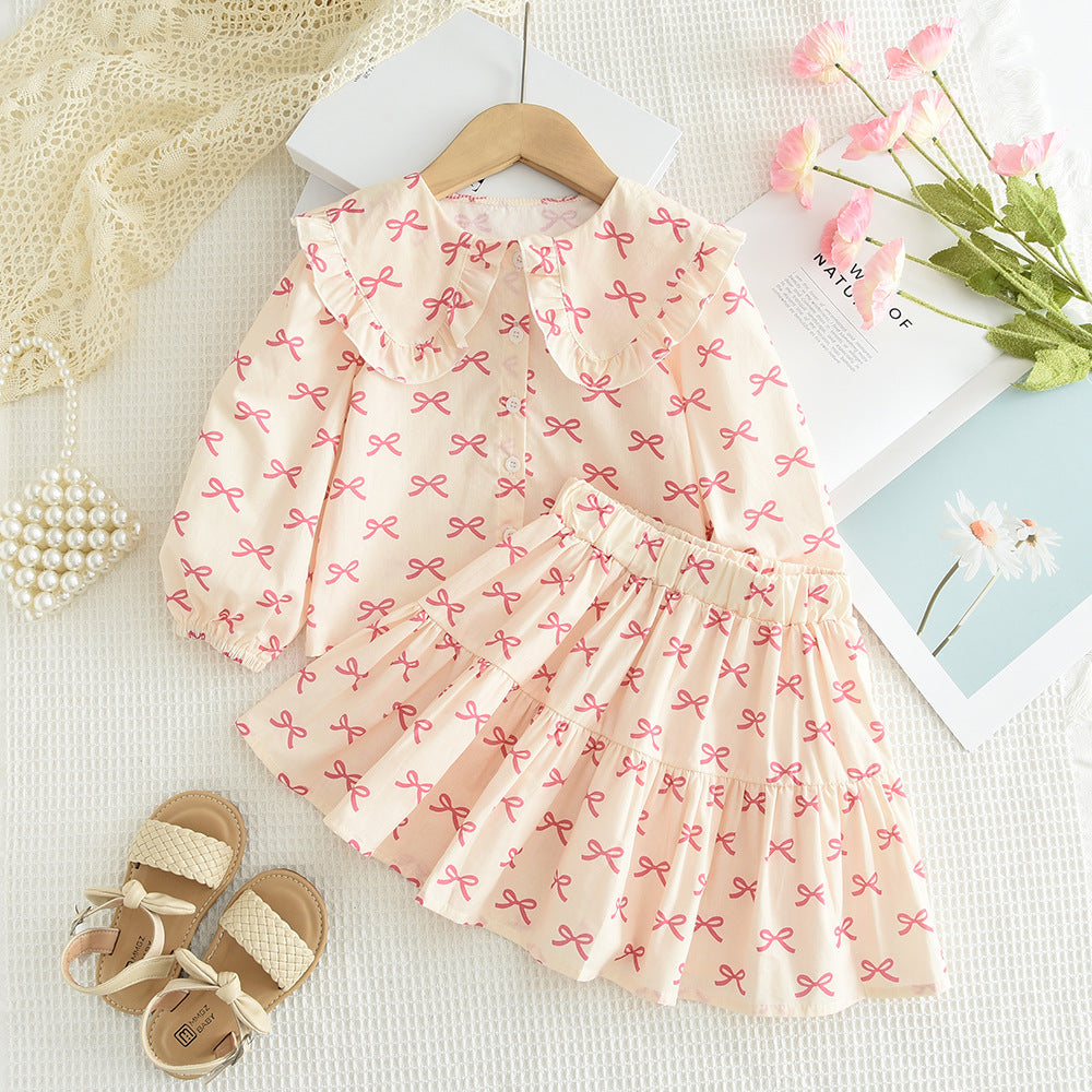 Cross-Border Hot-Selling Korean-Style Children's Clothing New Bow Print Long-Sleeve Doll Shirt Short Skirt Girls' 2026 Spring and Autumn Set